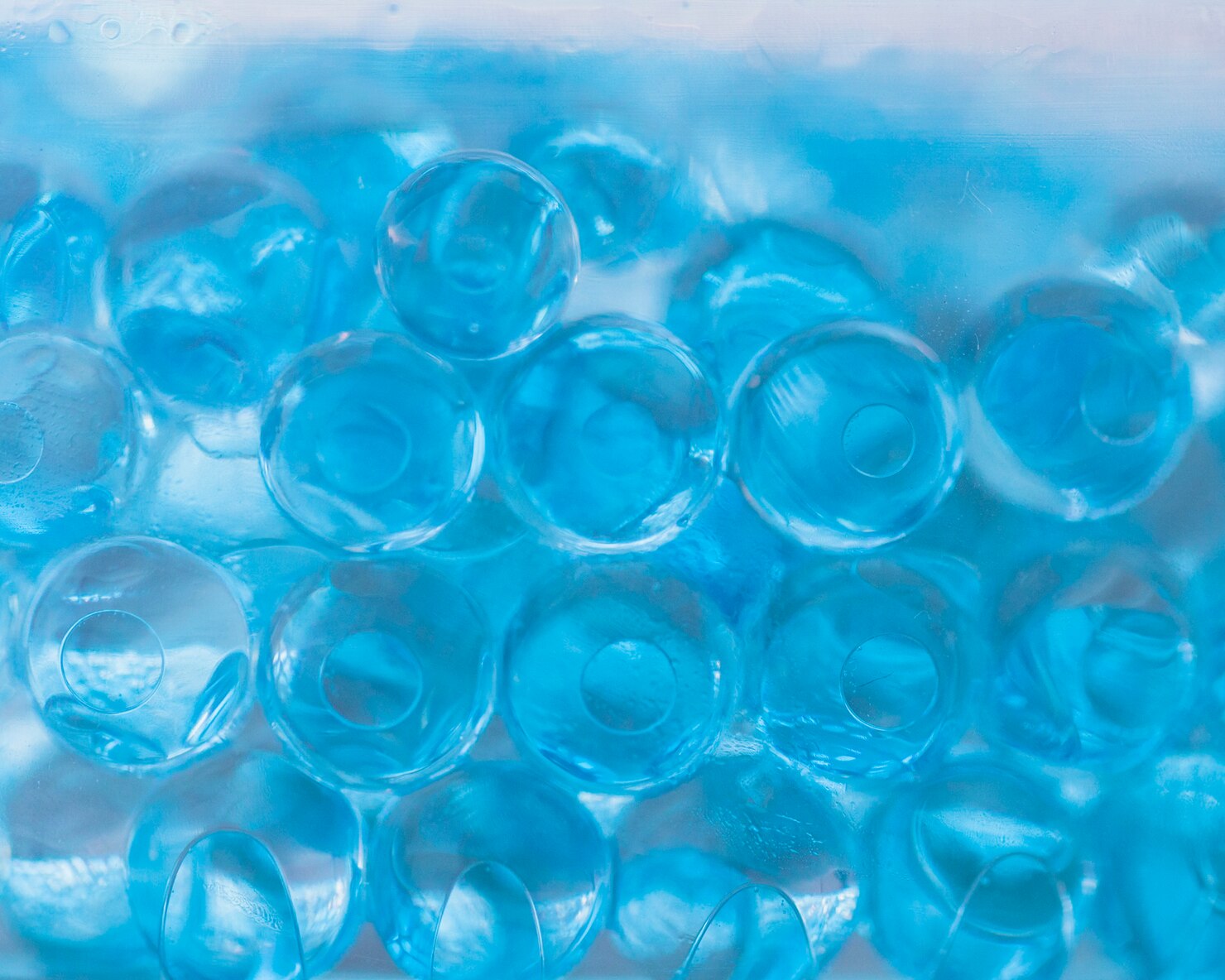 abstract-background-translucent-blue-hydrogel-balls_23-2148114633